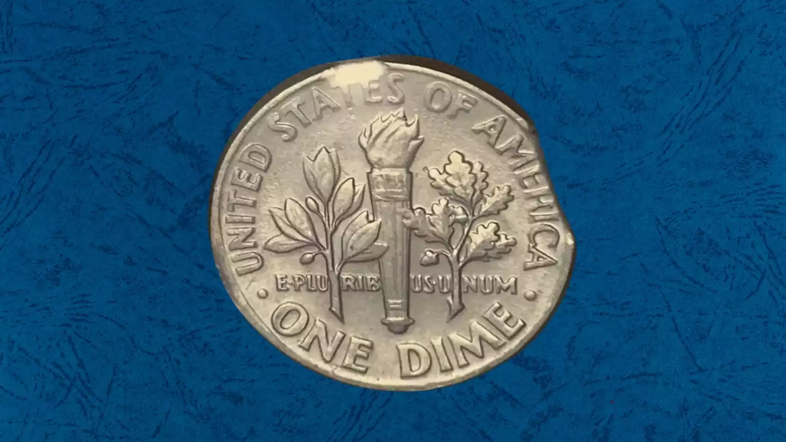 1971 dime clipped planchet error — crescent-shaped missing piece visible at the coin's rim